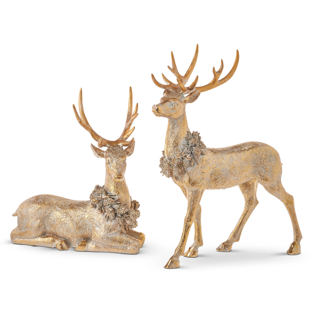 Two gold deer figurines on a white background