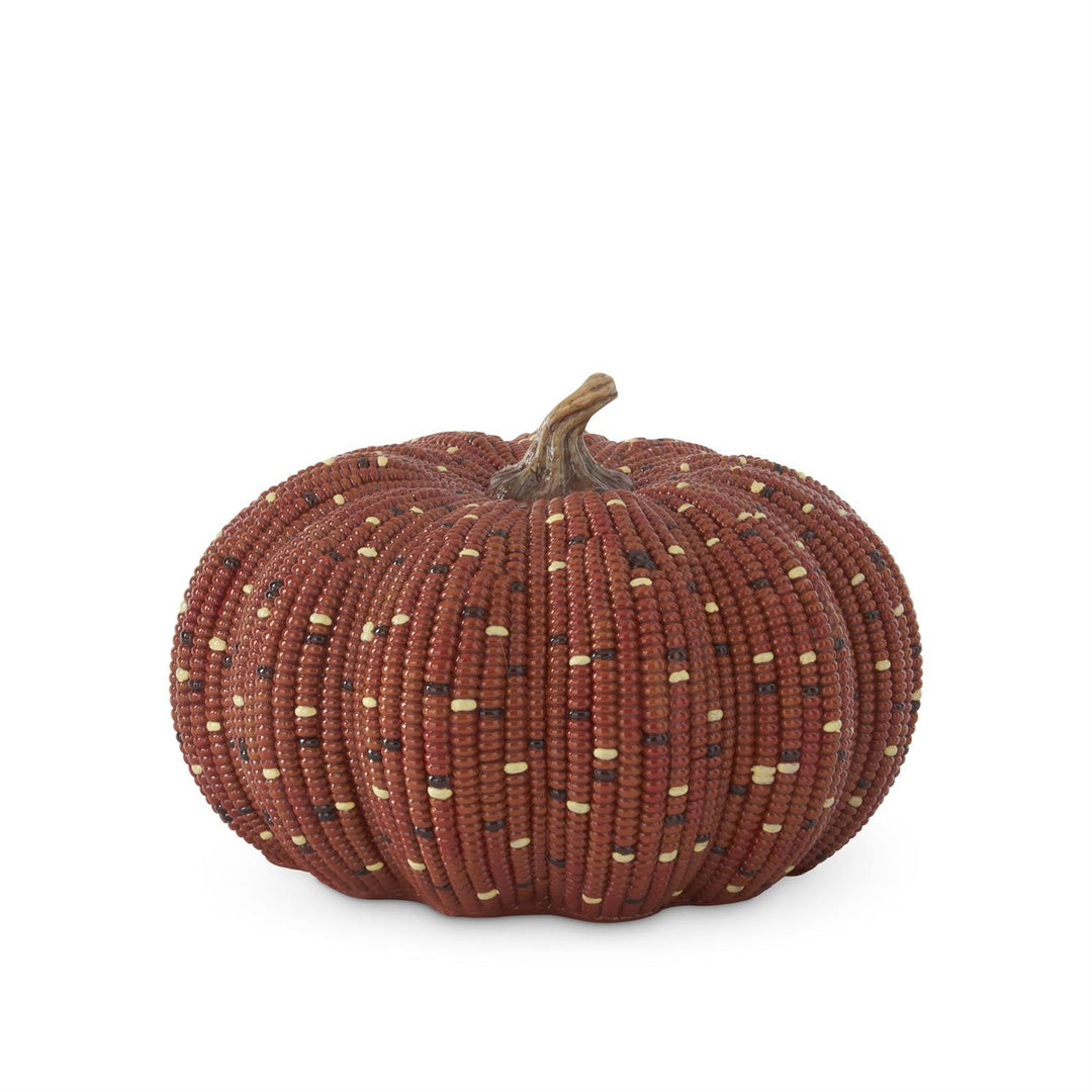 A decorative pumpkin-shaped basket made from woven reddish-brown beads with small scattered cream and dark accents, shown on a plain white background.