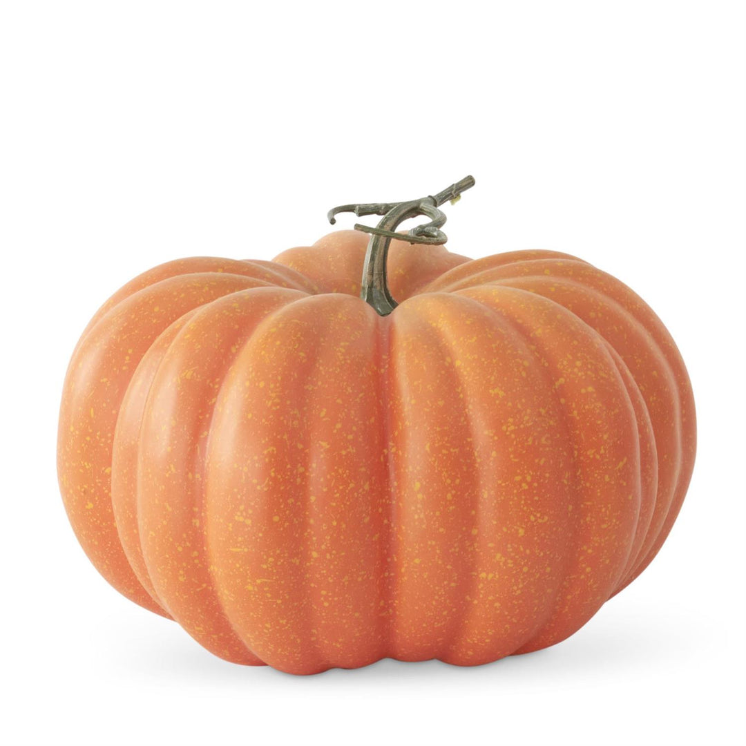 An orange decorative pumpkin with a textured speckled surface and a short brown stem, isolated on a white background.