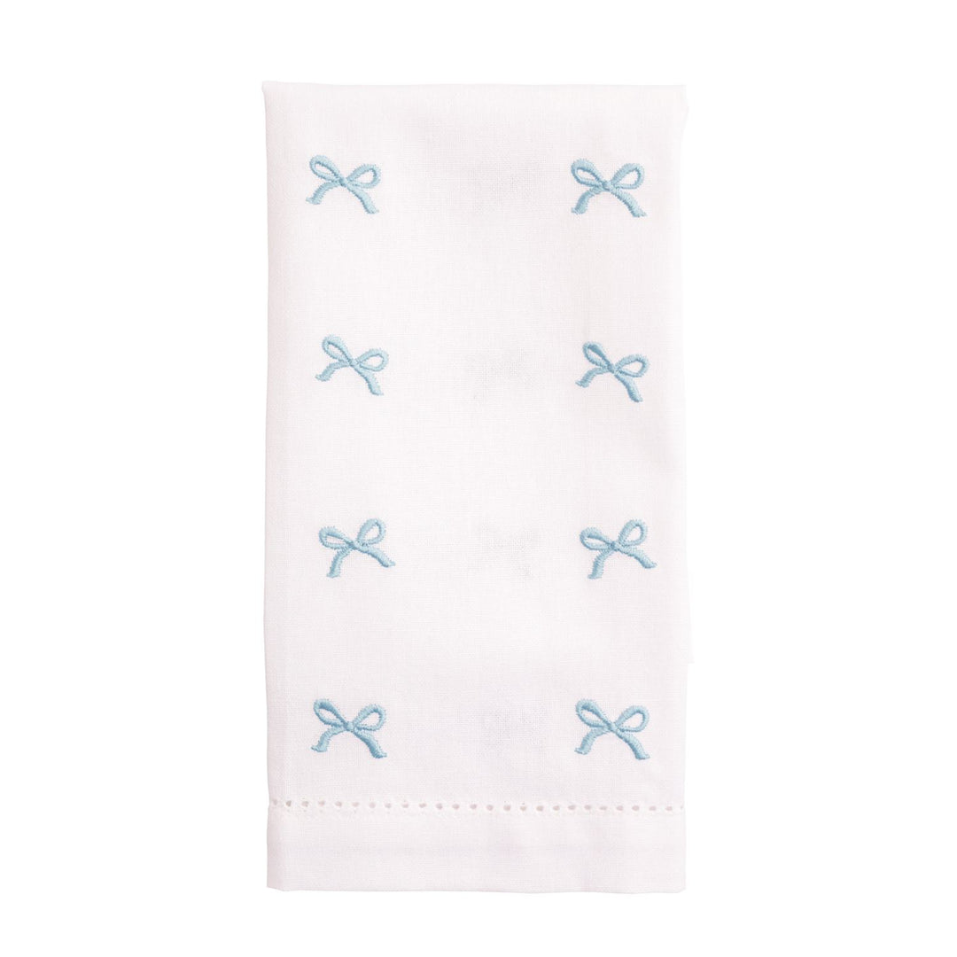 White napkin with blue embroidered bows on a white background