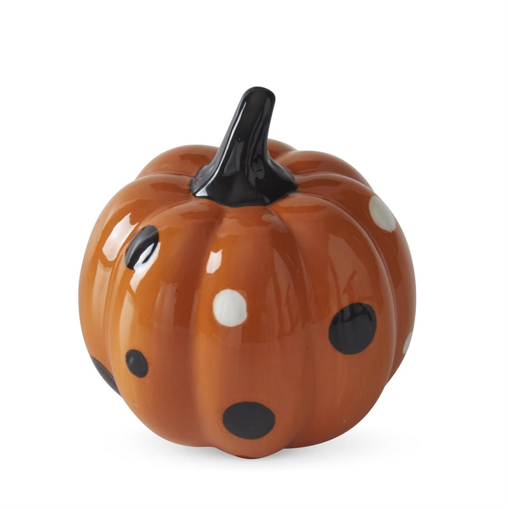 Ceramic pumpkin with black and white spots on a white background
