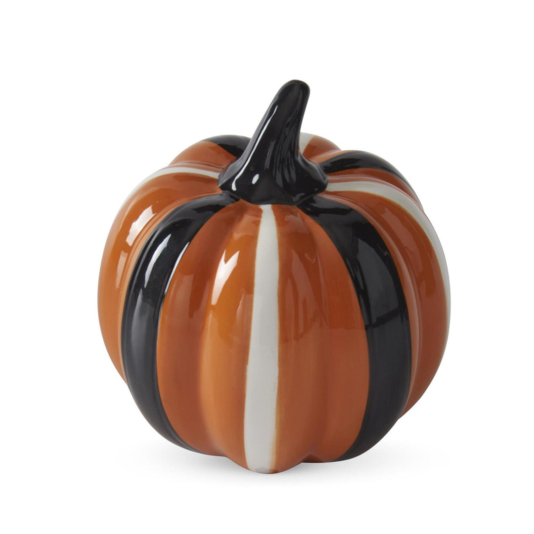 Decorative pumpkin with black and white stripes on a white background