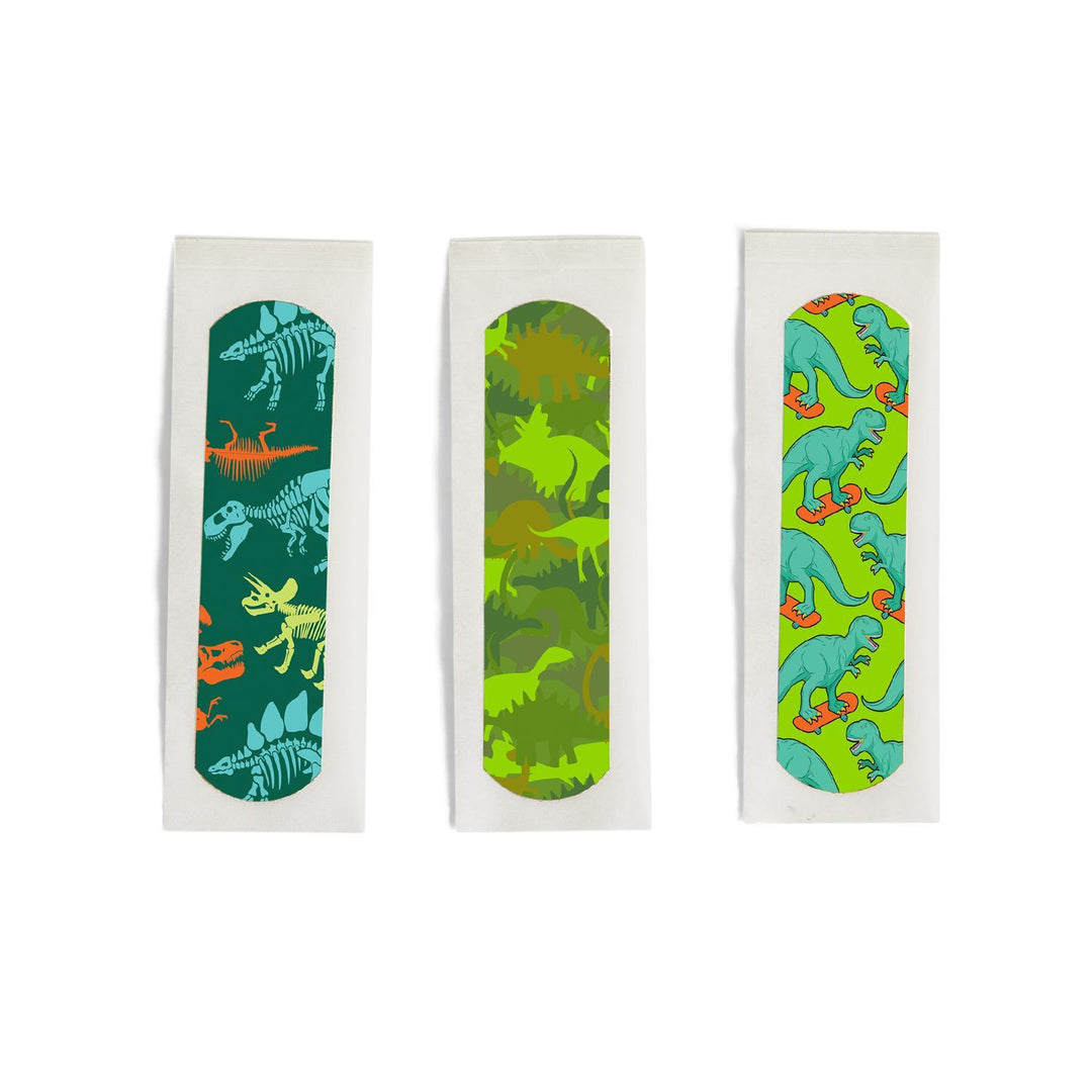 Three packages of dinosaur-themed band-aids on a white background