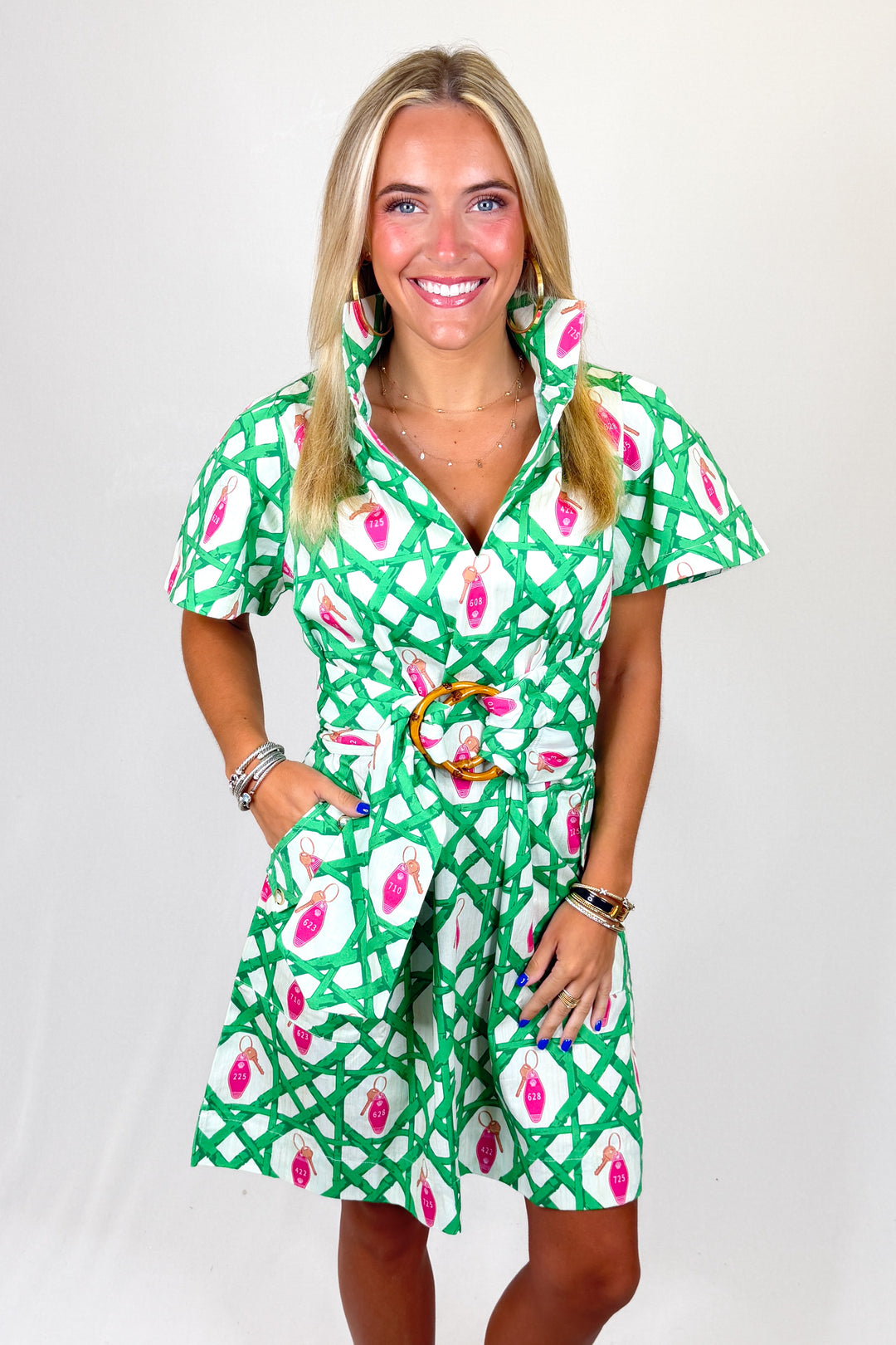 Woman wearing a green floral dress against a white background