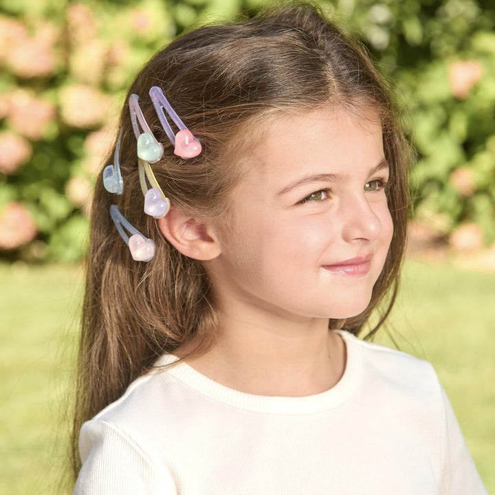 Young girl with colorful hair clips in her hair outdoors