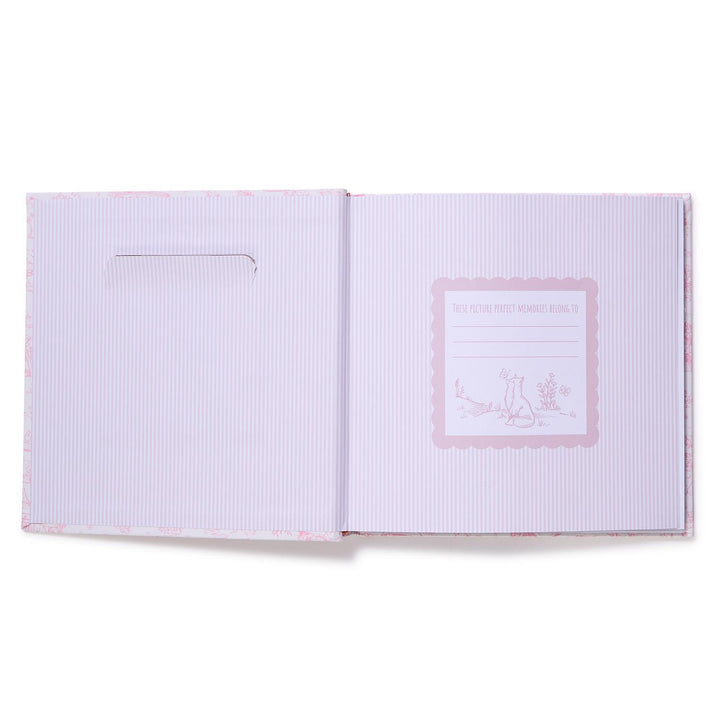 Open book with a pink logo on a white background