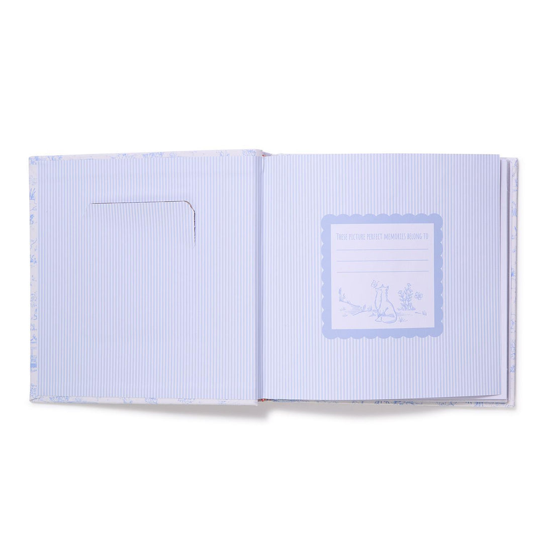 Open notebook with light blue cover and lined pages on a white background