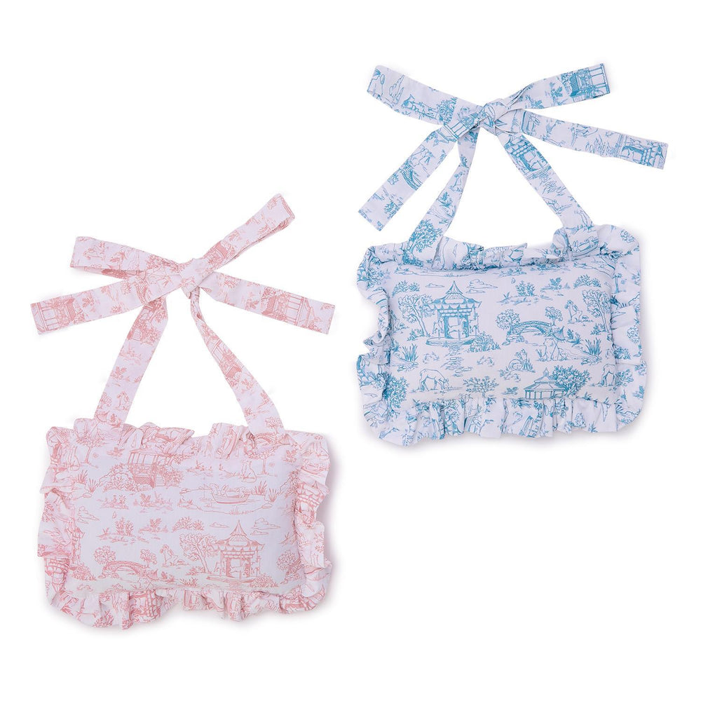 Two baby toile door pillows with floral patterns on a white background