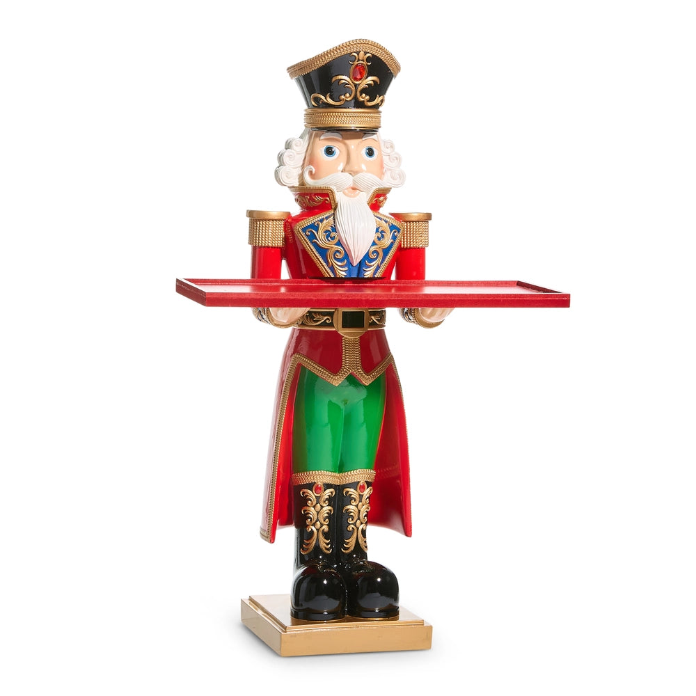 Decorative nutcracker figure holding a tray on a white background