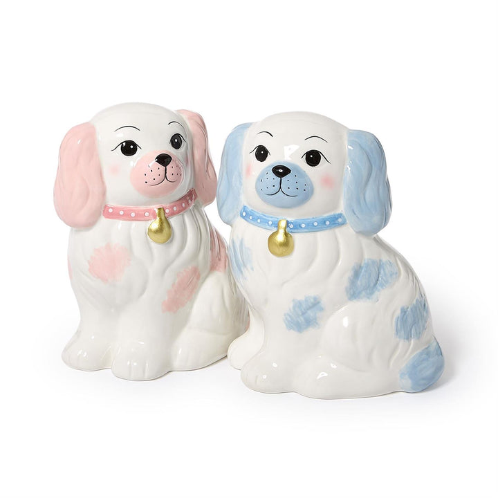 Two ceramic dog figurines with pink and blue collars on a white background