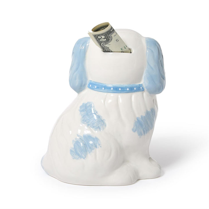 Dog-shaped money box with a dollar bill sticking out on a white background