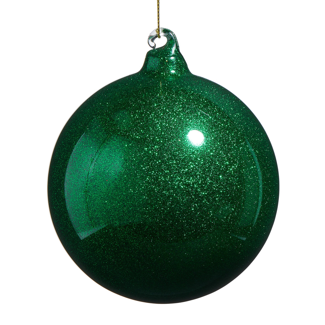Green glittery Christmas ball ornament on a white background