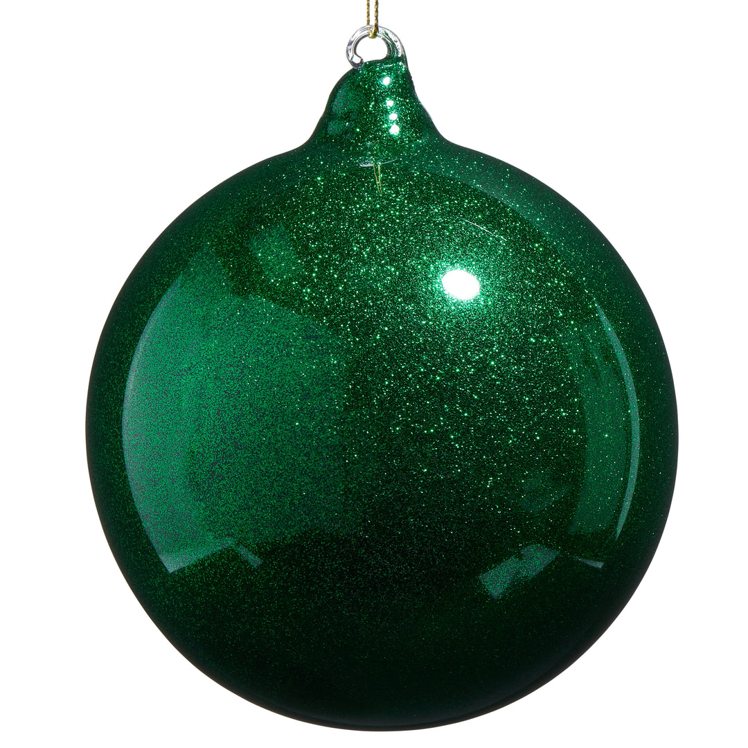 Green glittery Christmas ball ornament on a white background