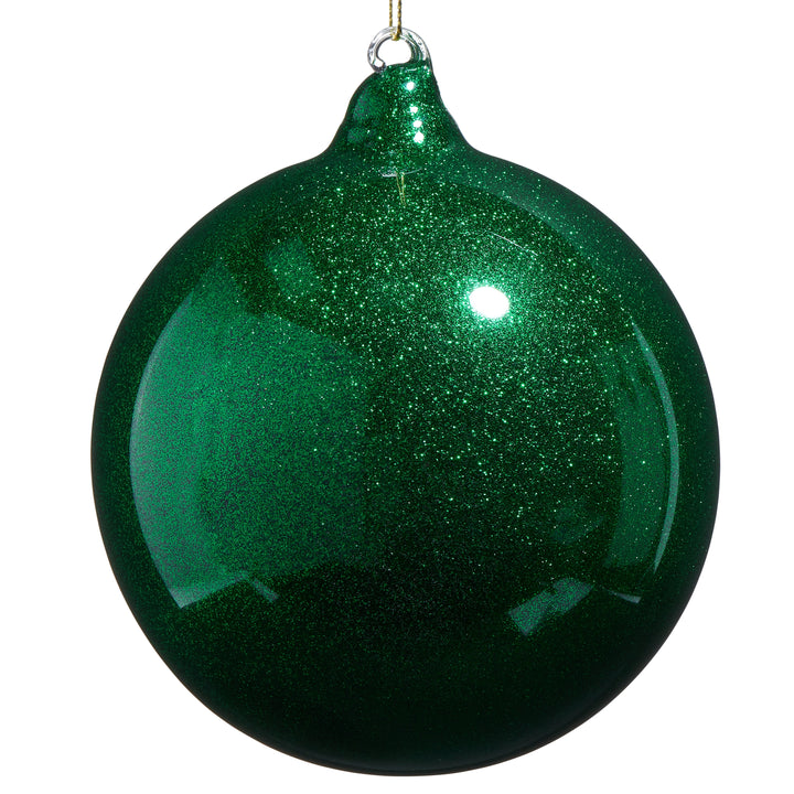 Green glittery Christmas ball ornament on a white background