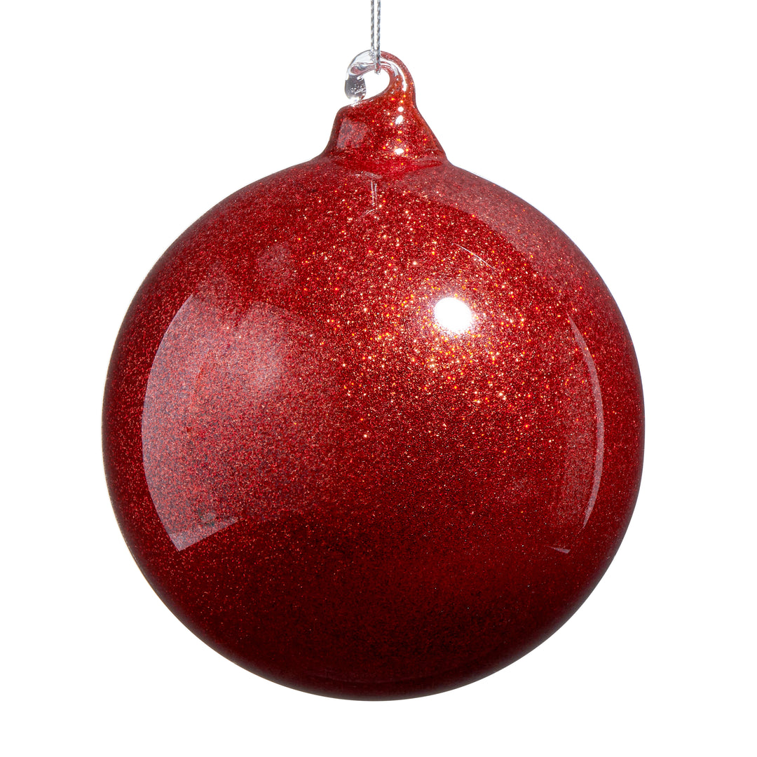 red glittery glass ornament on white background