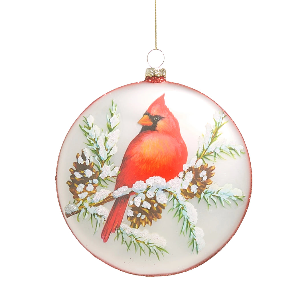 Round Christmas ornament with a red cardinal bird on a branch.