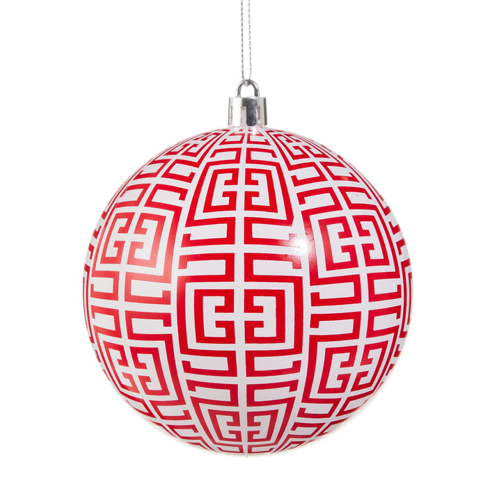 Red and white geometric patterned Christmas ball ornament on a white background