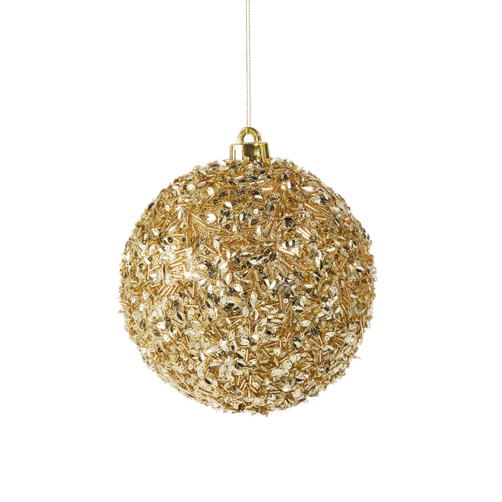 gold sequins on ornament on white background