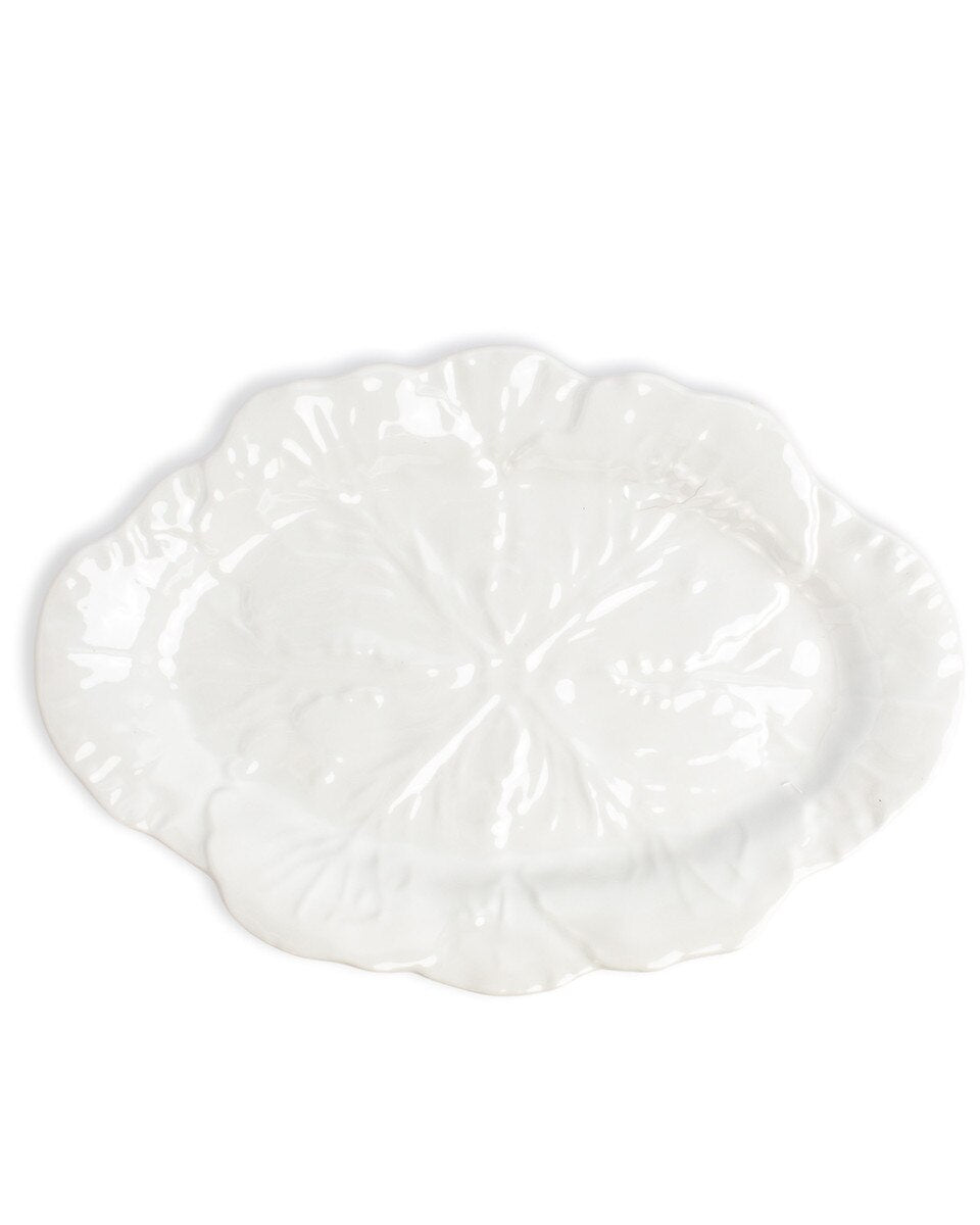 White decorative plate with intricate patterns on a white background