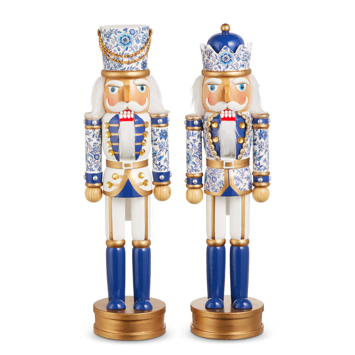 Two decorative nutcrackers with blue and gold accents on a white background