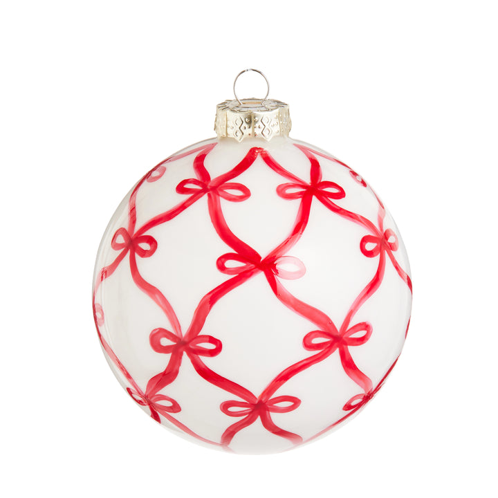 White Christmas ornament with red bow pattern on a white background