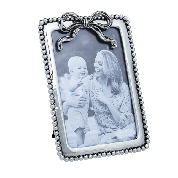 SILVER BEADED BOW FRAME ON WHITE BACKGROUND