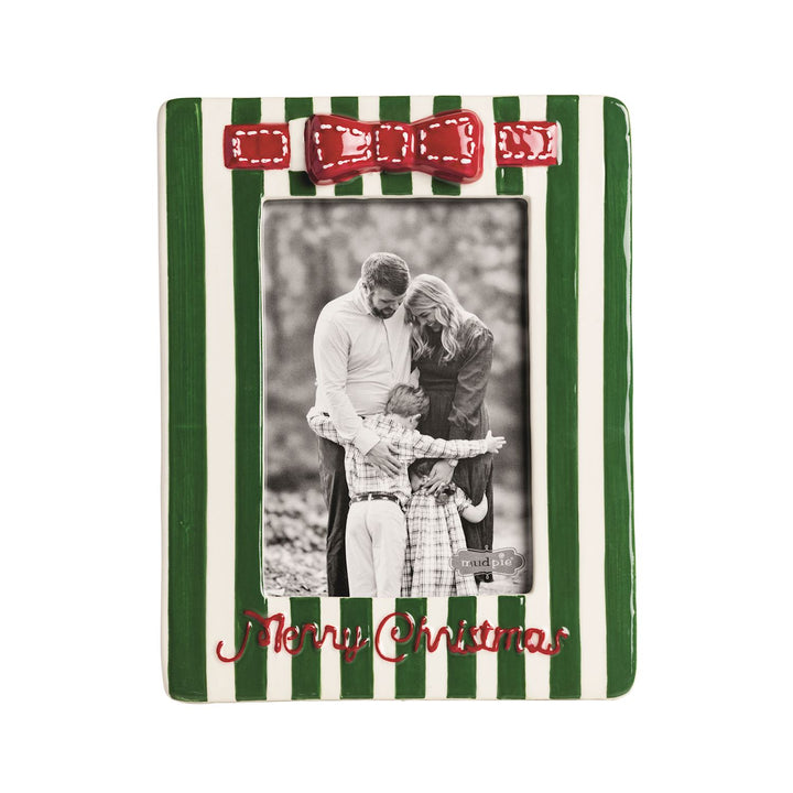 A ceramic Christmas picture frame with green and white vertical stripes, a red bow at the top, and &