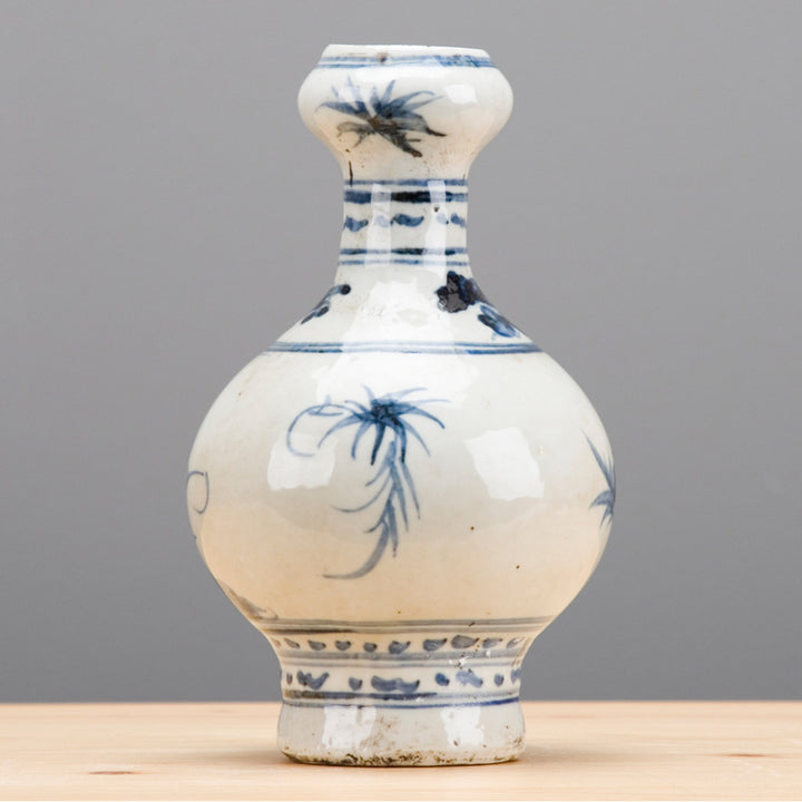 White ceramic vase with blue floral patterns on a gray background