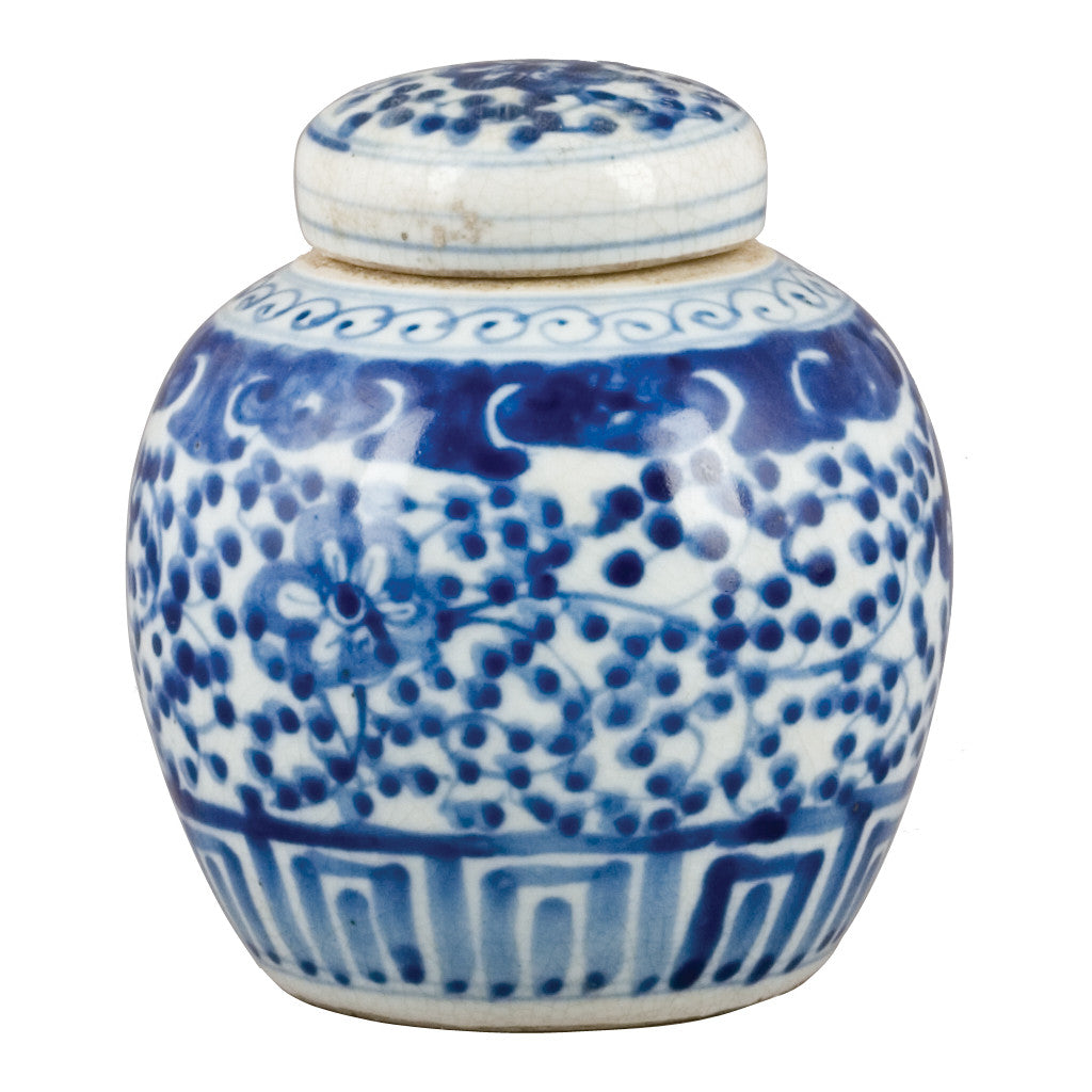A small blue and white glazed ceramic jar with a matching lid, decorated with traditional floral and geometric patterns.