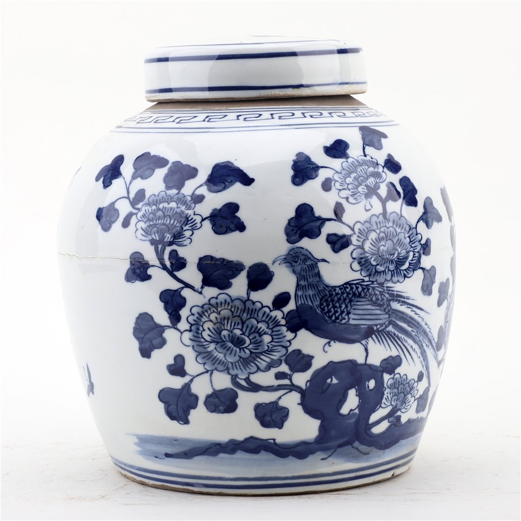 White ceramic jar with blue floral and bird patterns on a white background