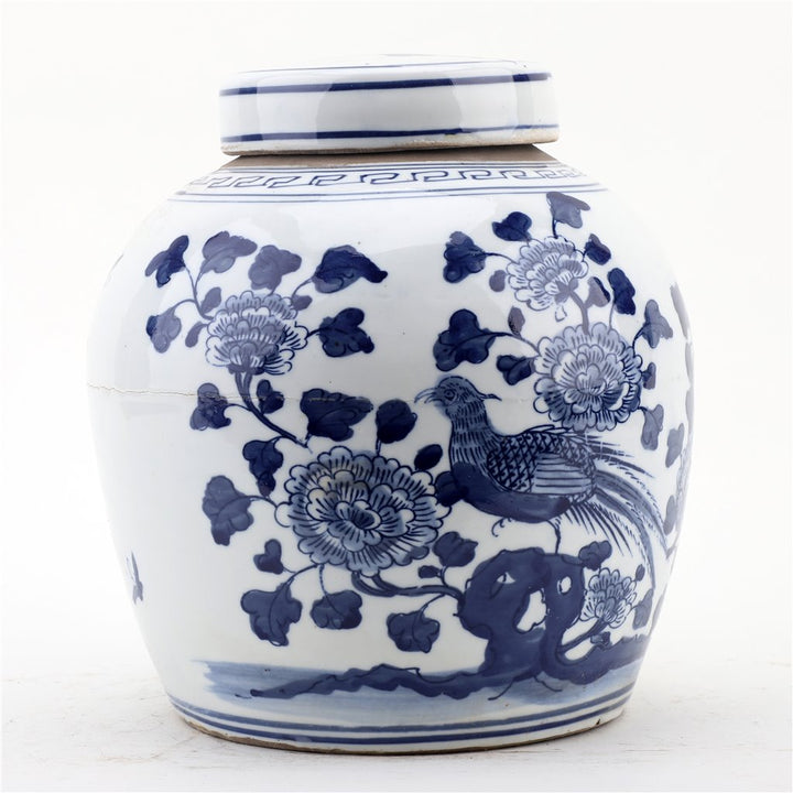 White ceramic jar with blue floral and bird patterns on a white background