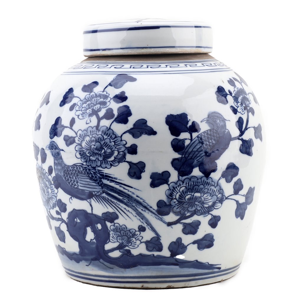 White ceramic jar with blue floral and bird patterns on a white background