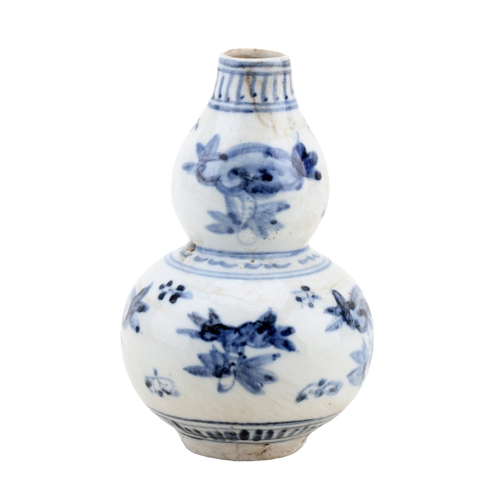 White ceramic vase with blue floral patterns on a white background