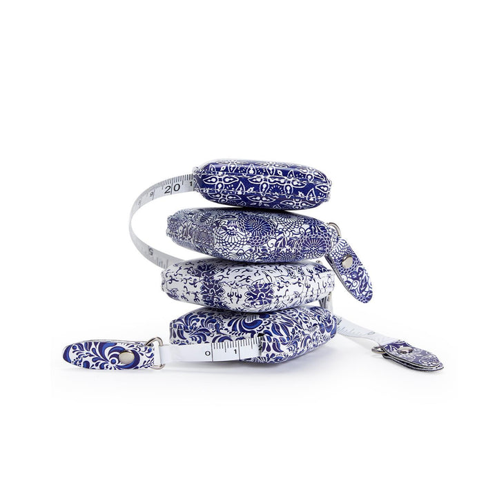 Measuring tape with blue floral pattern on a white background