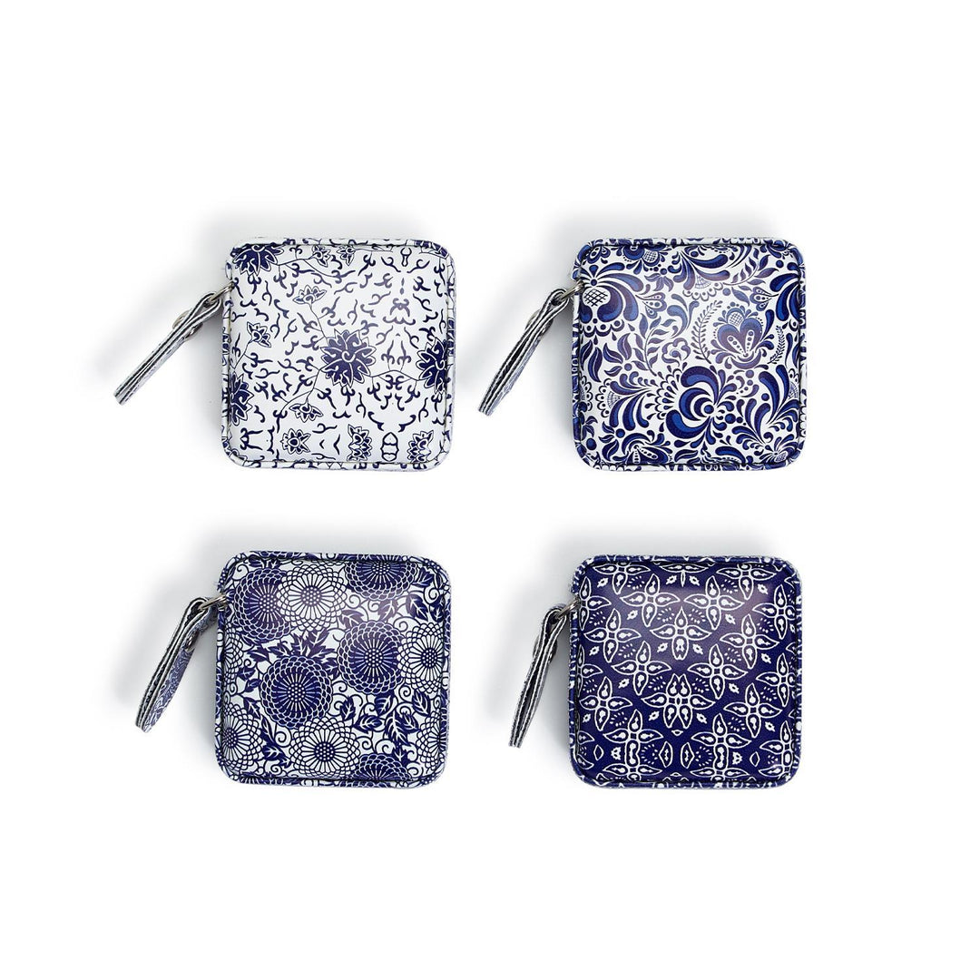 Four blue and white patterned coin purses on a white background