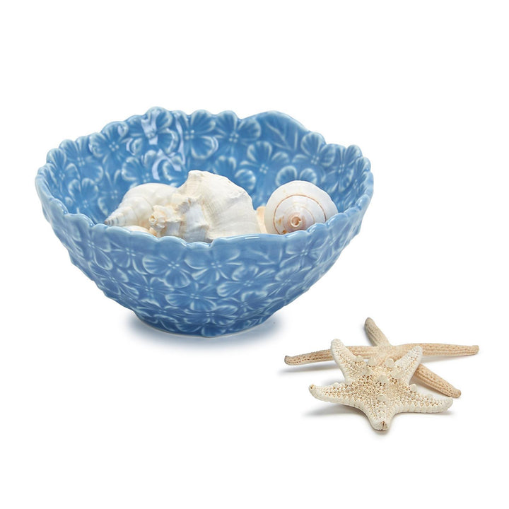 Blue decorative bowl with seashells and starfish on a white background