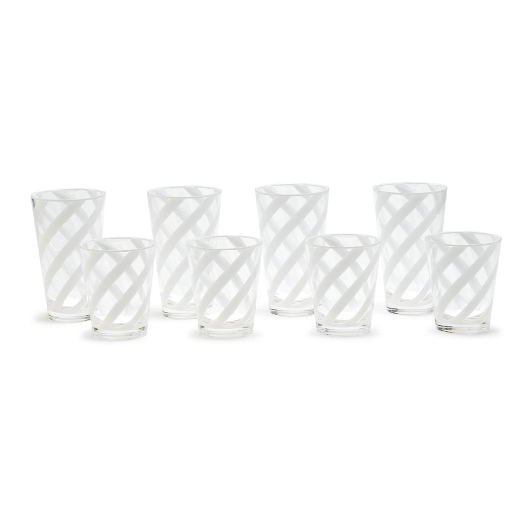 Set of six clear glass tumblers with white geometric patterns on a white background