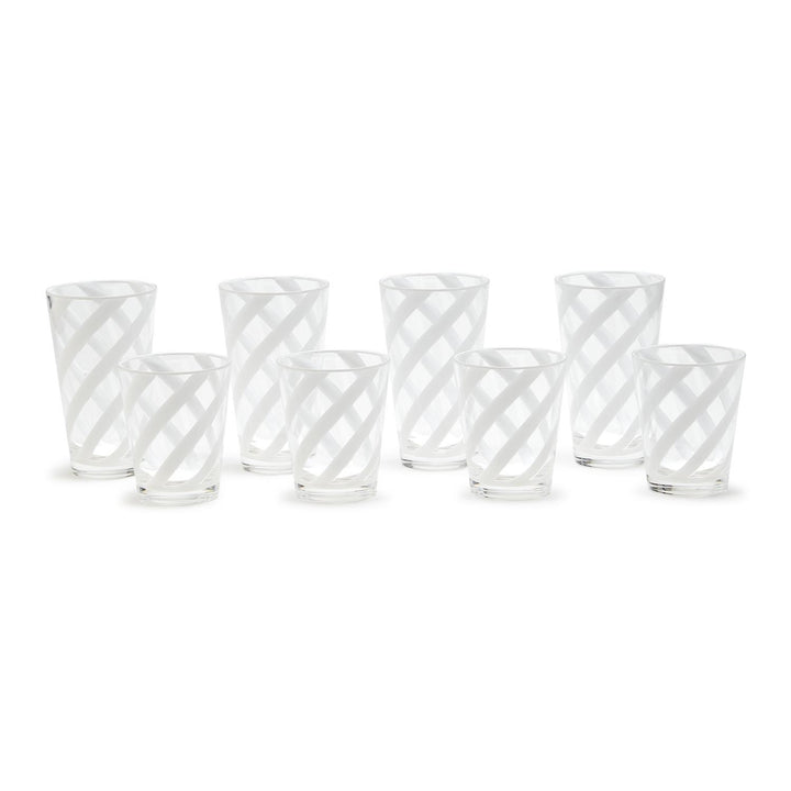 Set of six clear glass tumblers with white geometric patterns on a white background