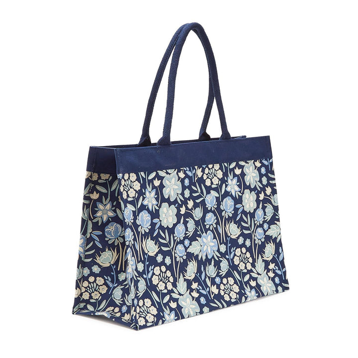 Floral-patterned tote bag with navy handle on a white background