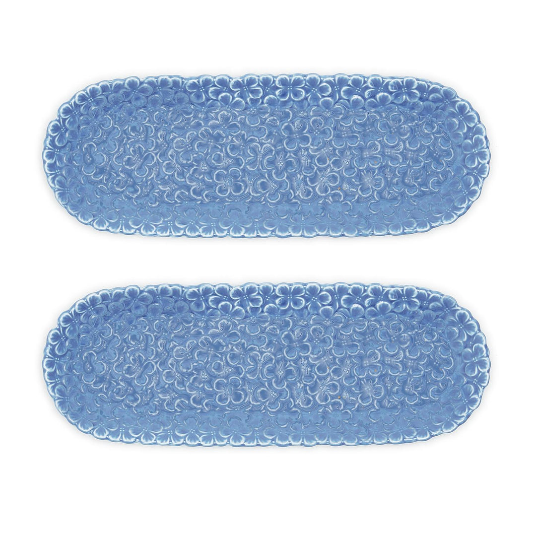 Two blue textured oval placemats on a white background