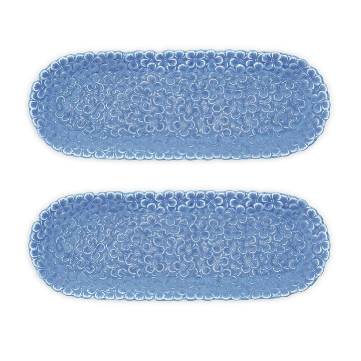 Two blue textured oval placemats on a white background