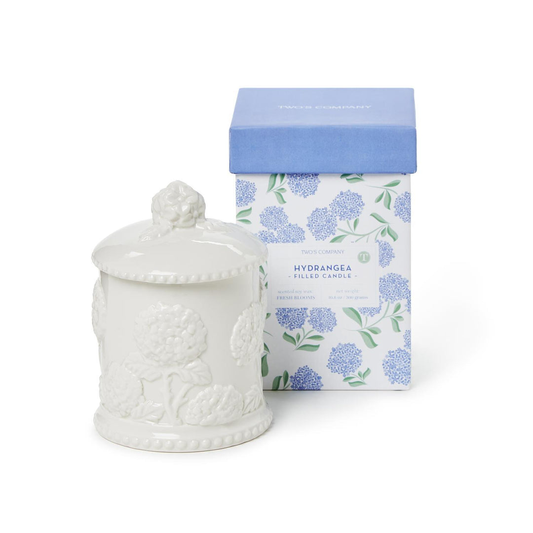 White ceramic jar with lid and floral-patterned box on a white background