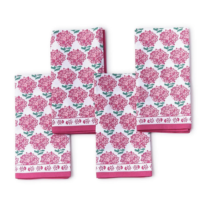 Set of four towels with pink floral pattern on a white background