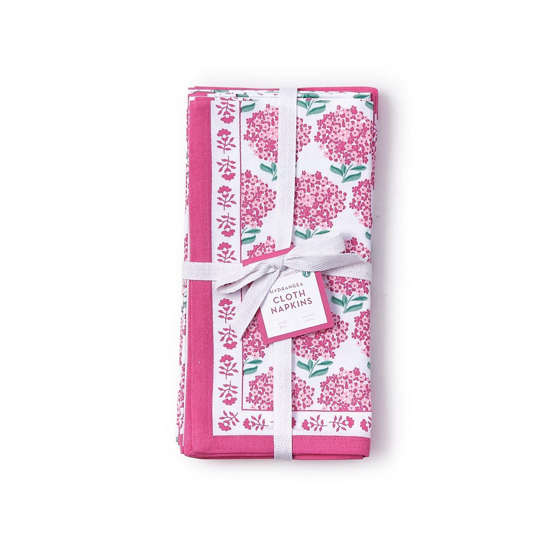 Set of floral-patterned cloth napkins with a white ribbon on a white background