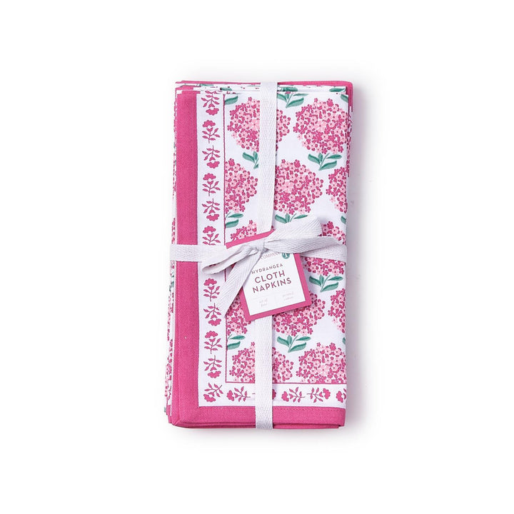 Set of floral-patterned cloth napkins with a white ribbon on a white background