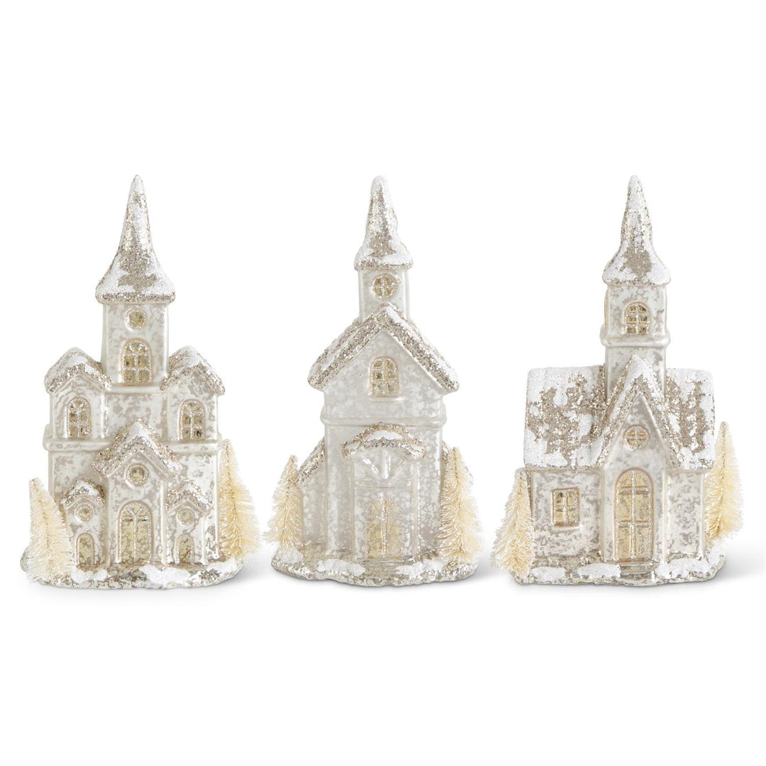Three decorative church models with a snowy texture on a white background