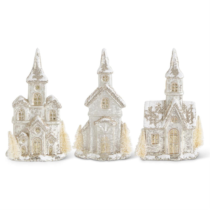Three decorative church models with a snowy texture on a white background
