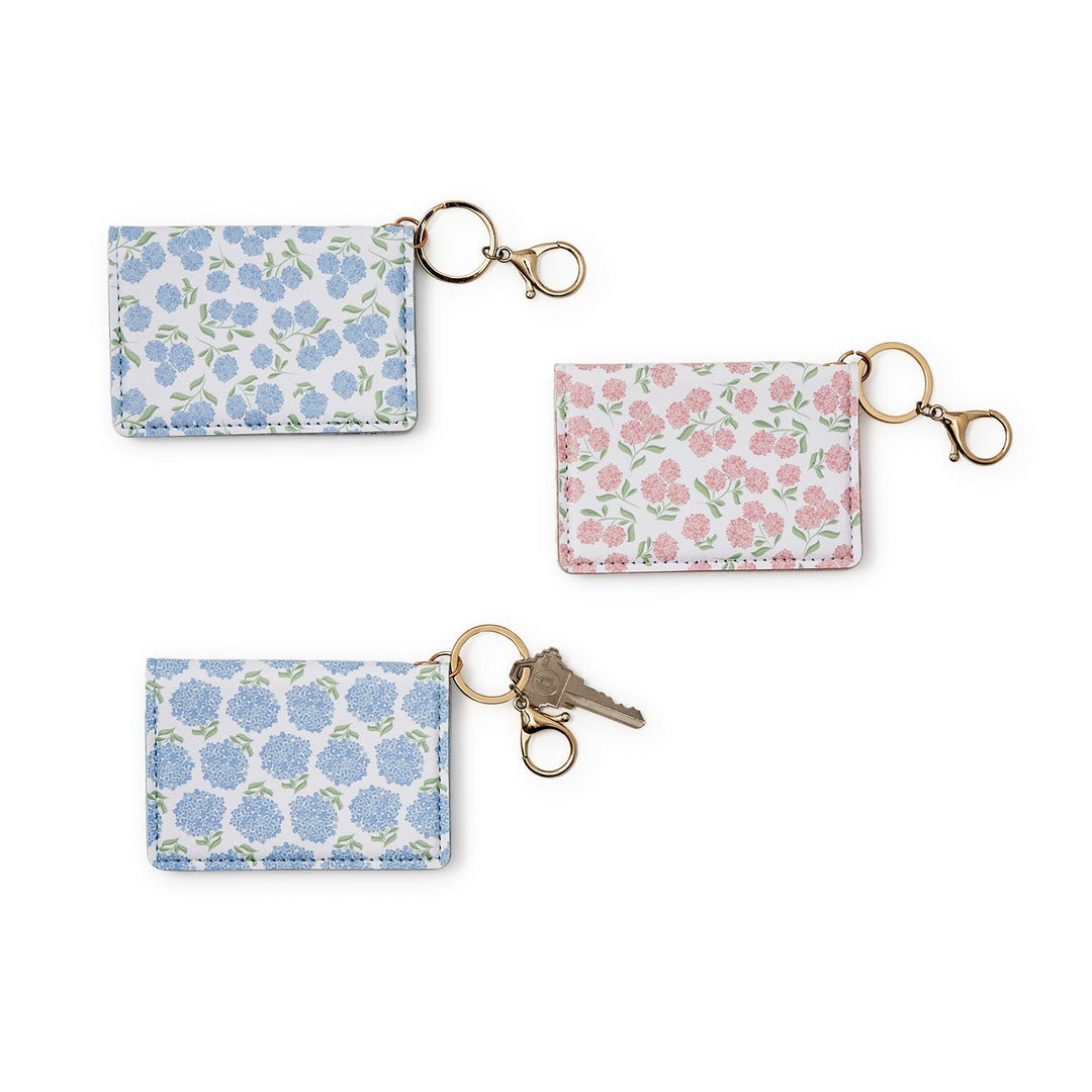 Set of three floral keychains on a white background