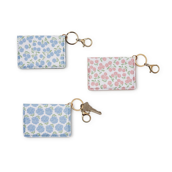 Set of three floral keychains on a white background