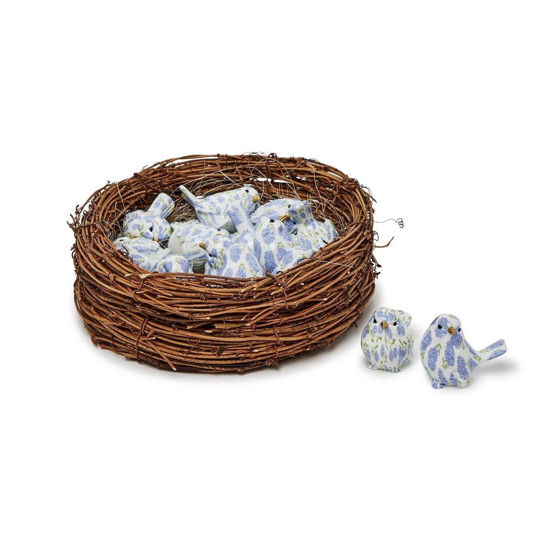 Decorative birds with floral pattern in a nest on a white background